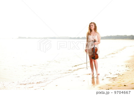 The blonde girl with a violin outdoor The blonde girl with a violin outdoor 9704667