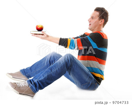 Man holding a book and one red apple full body 9704733