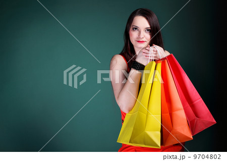 young woman with paper multi coloured shopping bag young woman with paper multi coloured shopping bag 9704802
