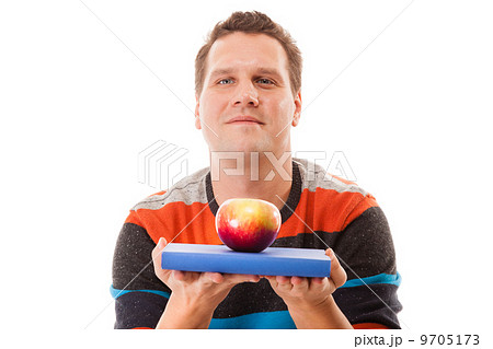 Man holding book and red apple. Healthy mind and body Man holding book and red apple. Healthy mind and body 9705173