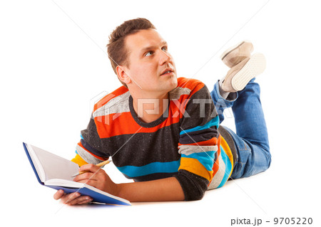 Man college student lying and reading book studying for exam 9705220