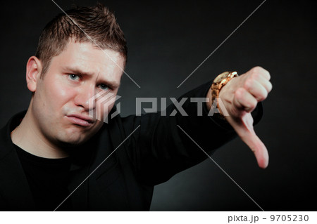 disappointed man signaling thumb down 9705230