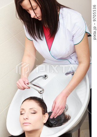 Hairstylist washing woman hair. Hairdressing beauty salon Hairstylist washing woman hair. Hairdressing beauty salon 9705536