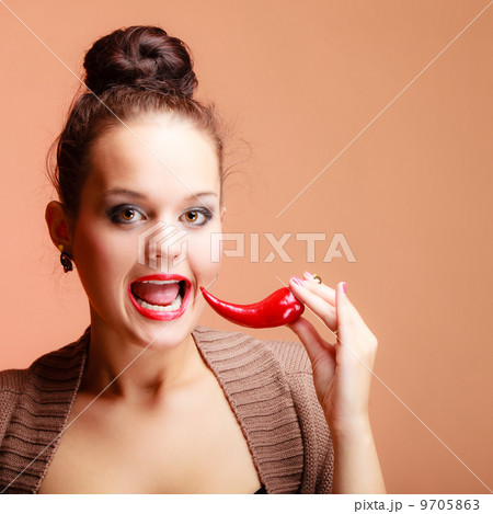 Beautiful woman fashion girl with red lips and chilli pepper Beautiful woman fashion girl with red lips and chilli pepper 9705863