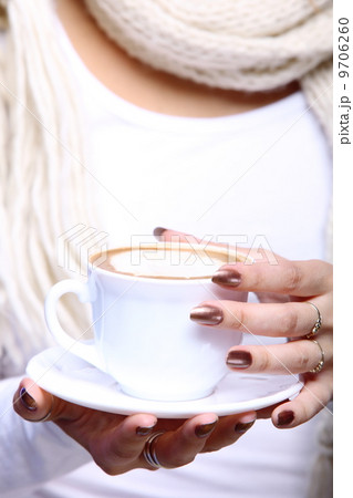 Female hands holding cup of hot latte coffee cappuccino Female hands holding cup of hot latte coffee cappuccino 9706260