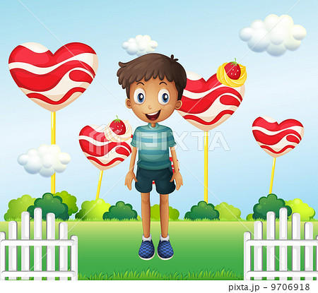 A smiling young boy standing in the garden with giant heart loll A smiling young boy standing in the garden with giant heart loll 9706918