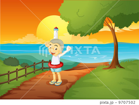 A young boy standing across the lighthouse 9707502