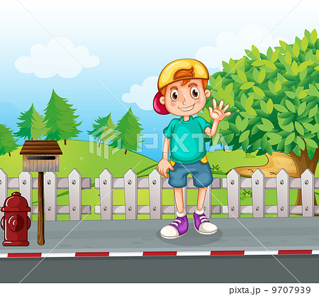A young boy standing at the streetside near the wooden mailbox A young boy standing at the streetside near the wooden mailbox 9707939