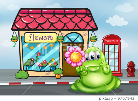 A three-eyed green monster holding a flower in front of the flow A three-eyed green monster holding a flower in front of the flow 9707942