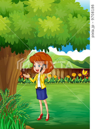 A woman with a cellphone standing under the tree 9708186