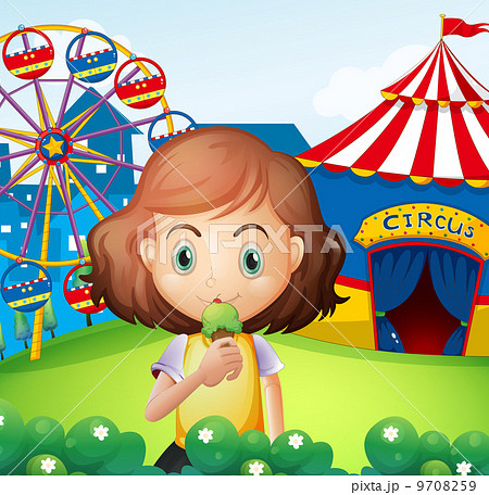 A girl at the carnival eating an icecream A girl at the carnival eating an icecream 9708259