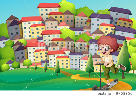 A happy boy playing with a scooter at the hills A happy boy playing with a scooter at the hills 9708356