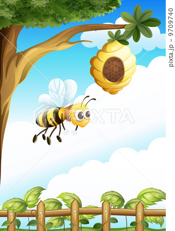 A tree near the fence with a beehive and a bee 9709740