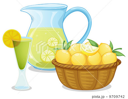 A basket of lemon beside the pitcher with lemonade 9709742
