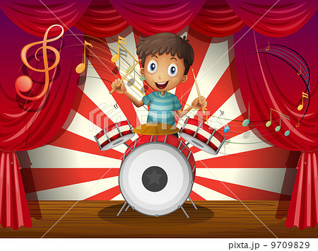 A boy at the center of the stage with a drum A boy at the center of the stage with a drum 9709829