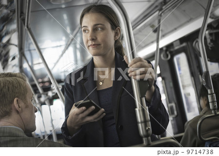 Business people in the city. Two people, a man and woman on a bus.  9714738