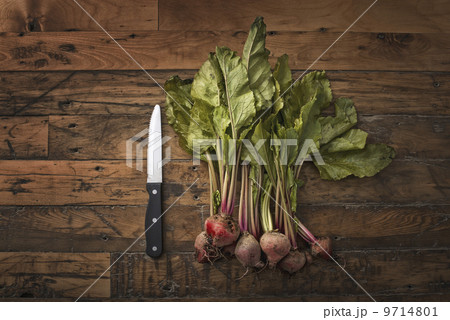 A handful of small beets, fresh organic vegetables harvested for the table. A vegetable knife. A handful of small beets, fresh organic vegetables harvested for the table. A vegetable knife. 9714801
