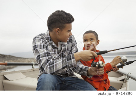A day out at Ashokan lake. Two boys fishing from a boat. A day out at Ashokan lake. Two boys fishing from a boat. 9714890