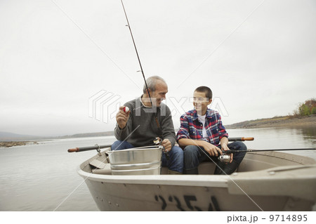 A day out at Ashokan lake. A man and a boy sitting fishing from the boat.  9714895