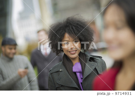 City life. A group of people on the go, keeping in contact, using mobile phones, and talking to each other. Men and women. 9714931