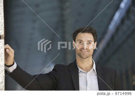 Business people in the city. Keeping in touch on the move. A man in a black jacket and open collared shirt.  9714996