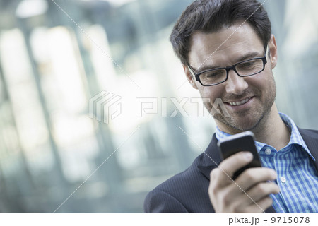 Business people in the city. Keeping in touch on the move. A man checking his cell phone.  9715078