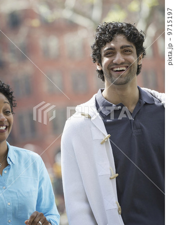 People outdoors in the city in spring time. New York City park. A man and woman side by side, smiling. 9715197