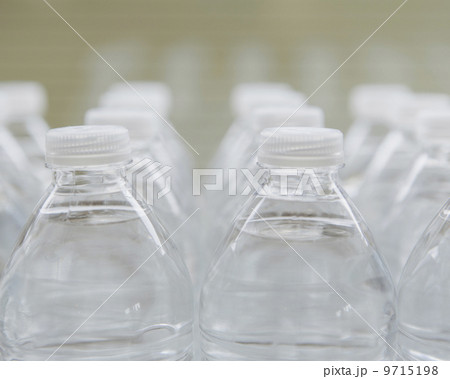 Rows of water-filled plastic bottles with screw caps.  9715198