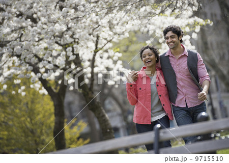 People outdoors in the city in spring time. New York City park. A man and woman side by side. People outdoors in the city in spring time. New York City park. A man and woman side by side. 9715510