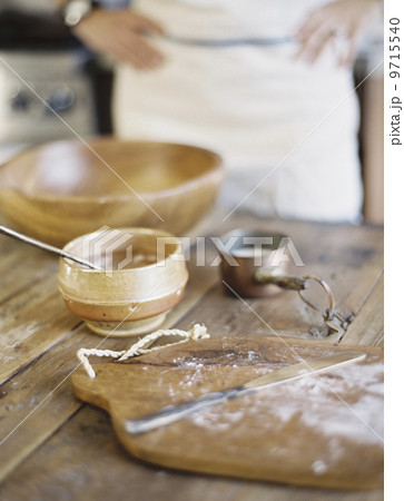 A domestic kitchen. A cook preparing a meal. A large bowl with oill and flour. Creating pastry.  9715540