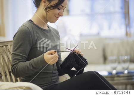 Woman relaxing at home with knitting 9715543