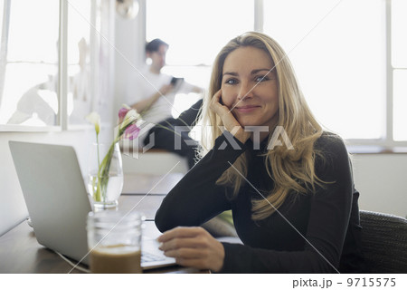 Couple at Home, Woman using Laptop and Man using Tablet Couple at Home, Woman using Laptop and Man using Tablet 9715575