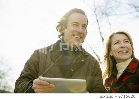 An Organic Farm in Winter in Cold Spring, New York State.  A man holding a digital tablet in his hands.  9715620