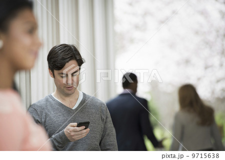 Young people outdoors on the city streets in springtime. Men and women.Two people, one checking his phone. Back view of two people in the park. Young people outdoors on the city streets in springtime. Men and women.Two people, one checking his phone. Back view of two people in the park. 9715638