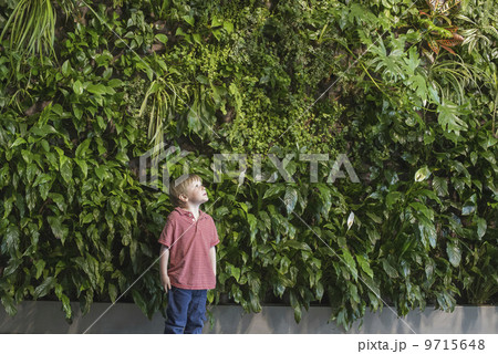 Outdoors in the city in spring. An urban lifestyle. A group of children on the sidewalk with school bags or book bags. Outdoors in the city in spring. An urban lifestyle. A group of children on the sidewalk with school bags or book bags. 9715648