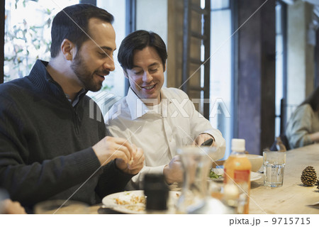 Men sharing text at restaurant table Men sharing text at restaurant table 9715715