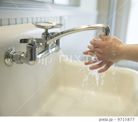 A boy washing his hands under the bathroom tap. A boy washing his hands under the bathroom tap. 9715877
