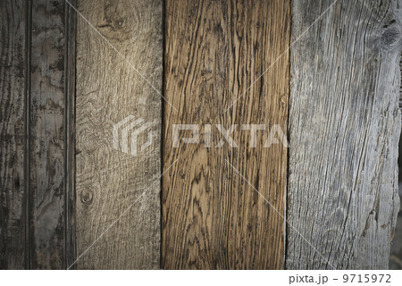 A heap of recycled reclaimed timber planks of wood. Environmentally responsible reclamation in a timber yard. Varieties of wood, with grain and colour details.  9715972