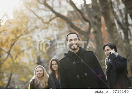 Adult group in urban park, man in front Adult group in urban park, man in front 9716140