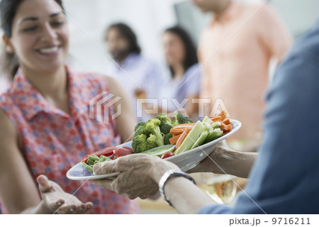An open plan office in New York City. A working lunch, a salad buffet. A group of men and women of mixed ages and ethnicities meeting together. An open plan office in New York City. A working lunch, a salad buffet. A group of men and women of mixed ages and ethnicities meeting together. 9716211