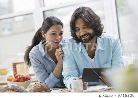 An office or apartment interior in New York City. A couple side by side by the breakfast bar. Food and fresh fruit. An office or apartment interior in New York City. A couple side by side by the breakfast bar. Food and fresh fruit. 9716306