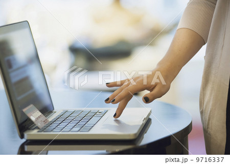 Woman on-line shopping on laptop 9716337