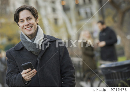 Man in urban park with smartphone 9716478