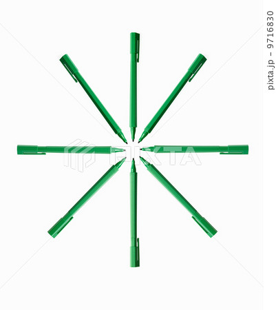 Office supplies. Green coloured pens, felt nibs and pen top cases, arranged in a star shape. 9716830