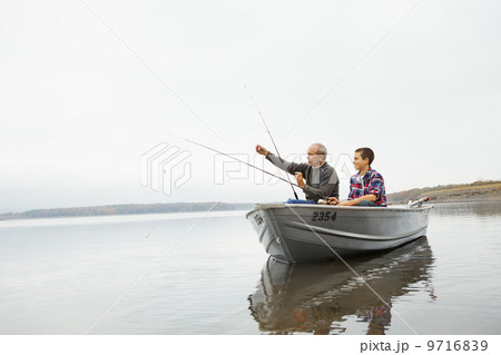 A day out at Ashokan lake. A man and a teenage boy fishing from a boat. A day out at Ashokan lake. A man and a teenage boy fishing from a boat. 9716839