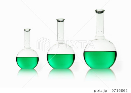 Three rounded shaped scientific chemical flasks holding green liquid, arranged in size order. Three rounded shaped scientific chemical flasks holding green liquid, arranged in size order. 9716862