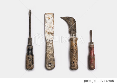 Used tools arranged in a row. Well used, worn handles, shaped wooden smooth texture. Metal rusty and marked implements. Used tools arranged in a row. Well used, worn handles, shaped wooden smooth texture. Metal rusty and marked implements. 9716906