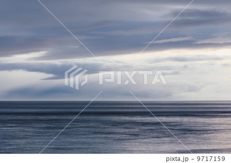 The sea and sky over Puget Sound in Washington, USA. The horizon with light cloud layers above. 9717159