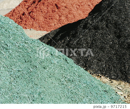 Piles of multi-colored bark wood chips used for landscaping, near Quincy 9717215