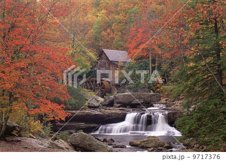 A historic grist mill building on the banks of Glade Creek in West Virginia. 9717376